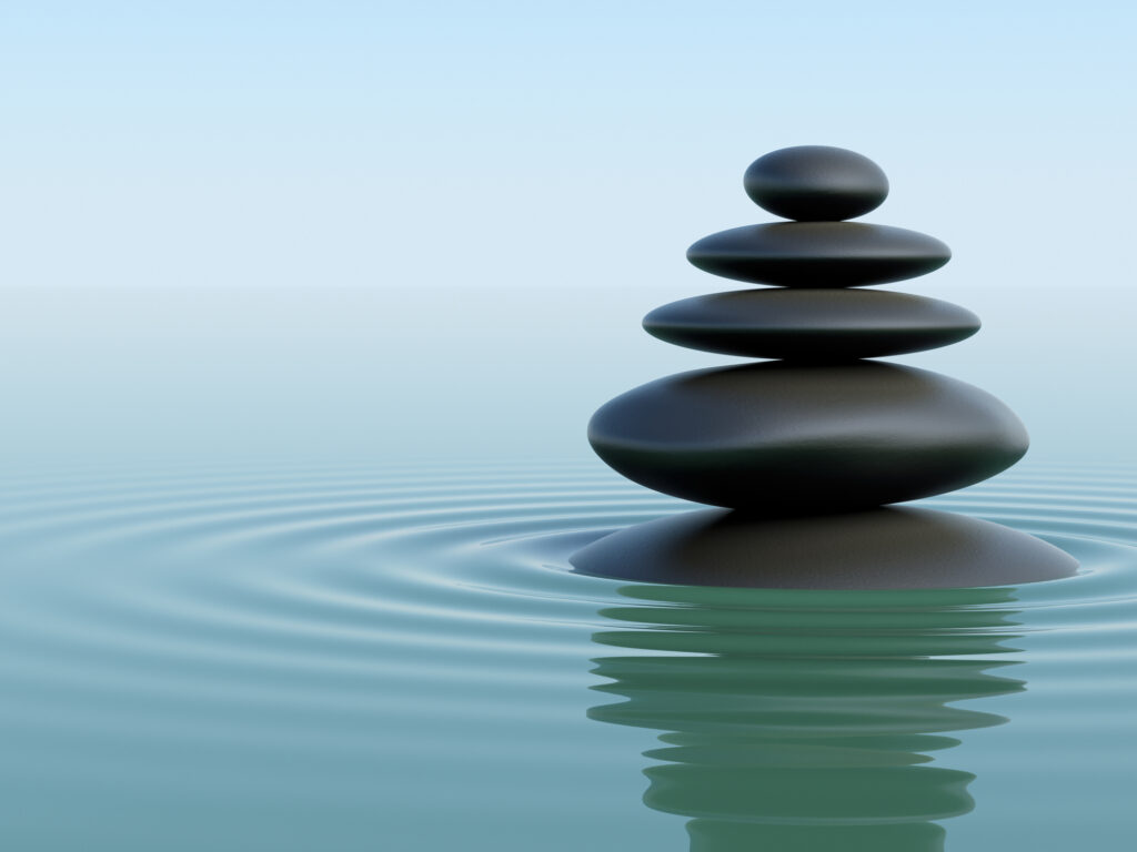A stack of balanced stones represent holistic employee engagement.